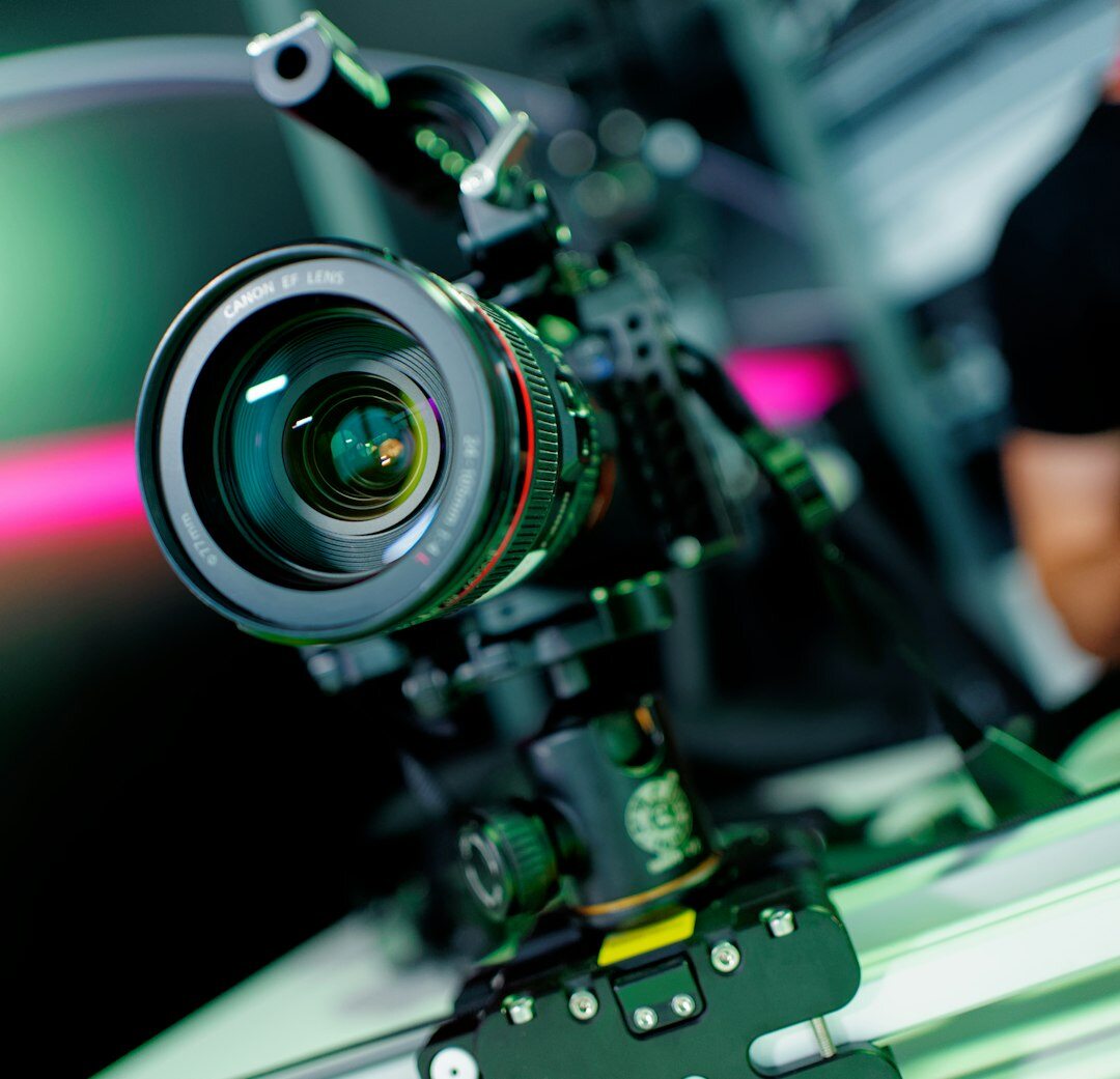 Male camera operator holding a professional broadcast camera