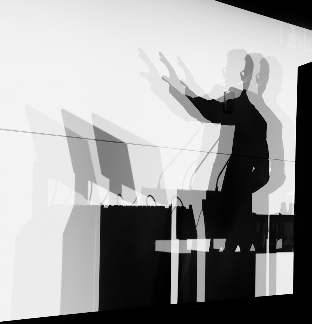 Male technical director standing in front of broadcast monitors